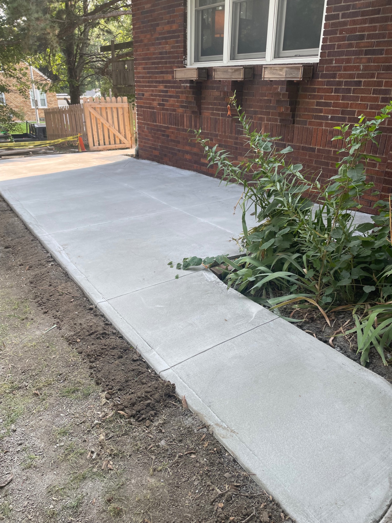 Concrete Patio Along Brick Home — Close view